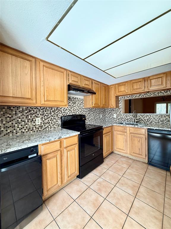 4513 North O'Connor Road, Unit 2133 Irving, TX 75062 - Photo 10 of 33 a kitchen with granite countertop a stove sink and cabinets