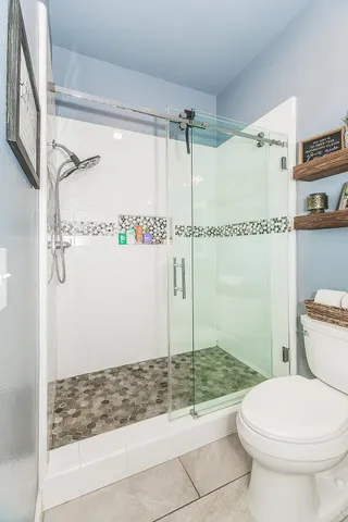 a spacious bedroom with a bed and a chandelier