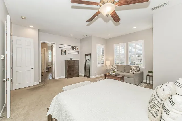 a spacious bathroom with a double vanity sink toilet and shower
