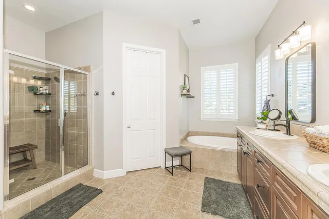 a bathroom with a bathtub and a shower