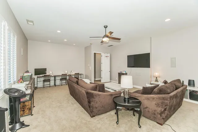 a view of a house with swimming pool and sitting area