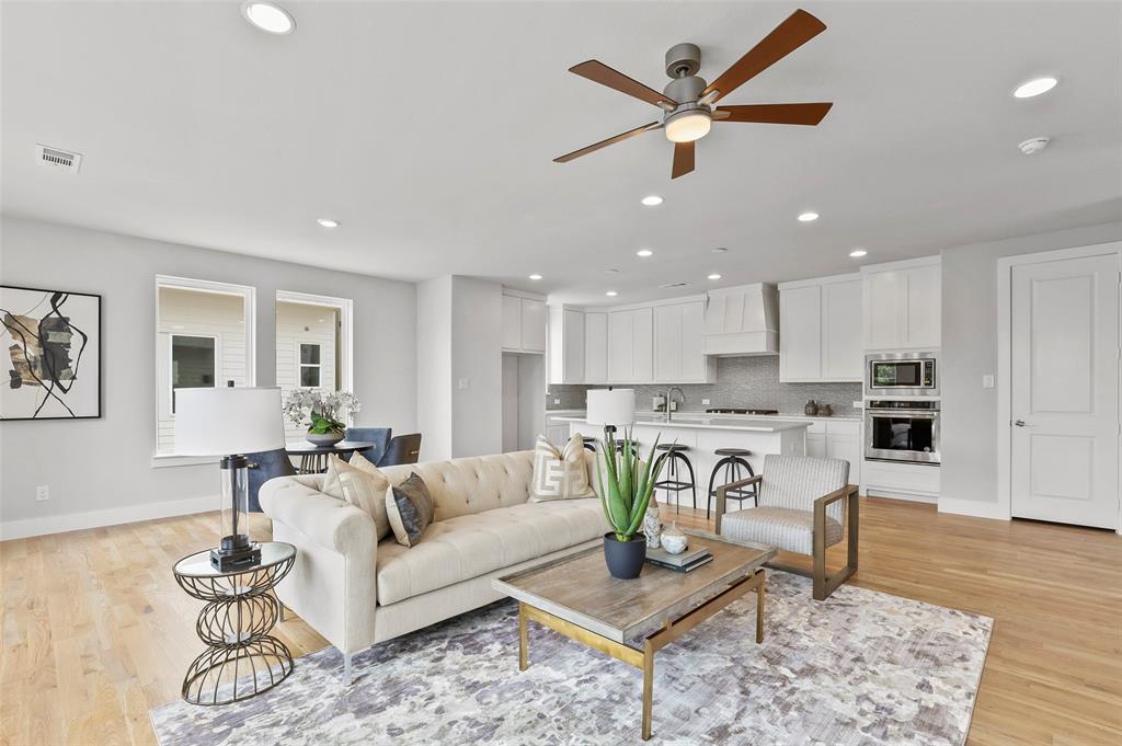 a living room kitchen with furniture and a view of kitchen