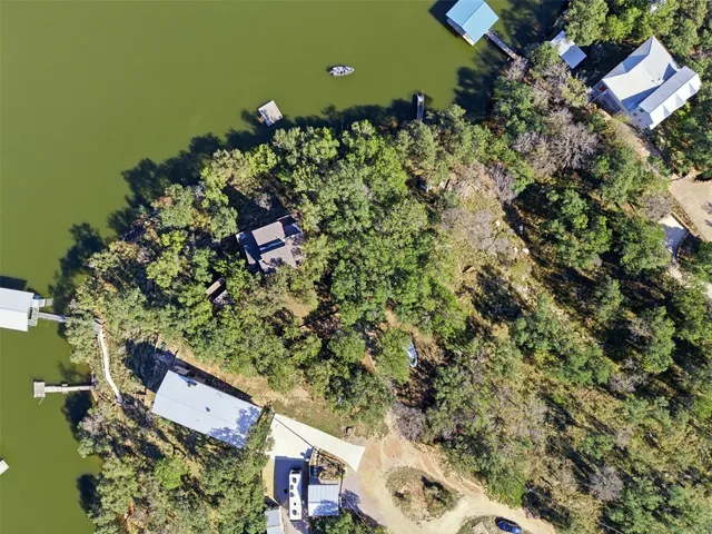 an aerial view of a house with a yard