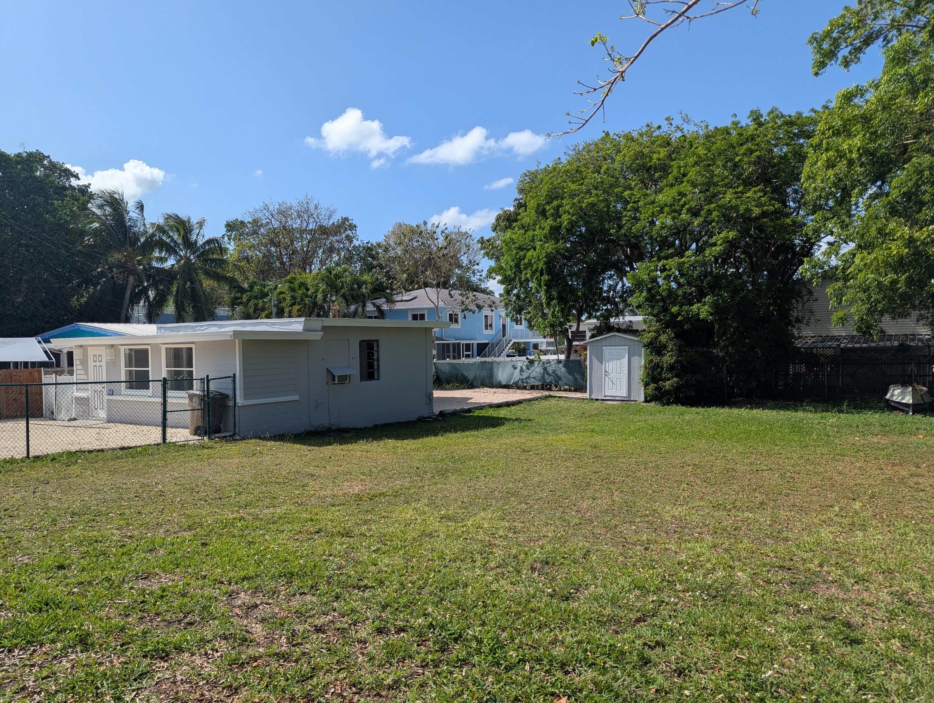 16-18 Dolphin Road Key Largo, FL 33037 - Photo 3 of 3 a backyard of a house with lots of green space
