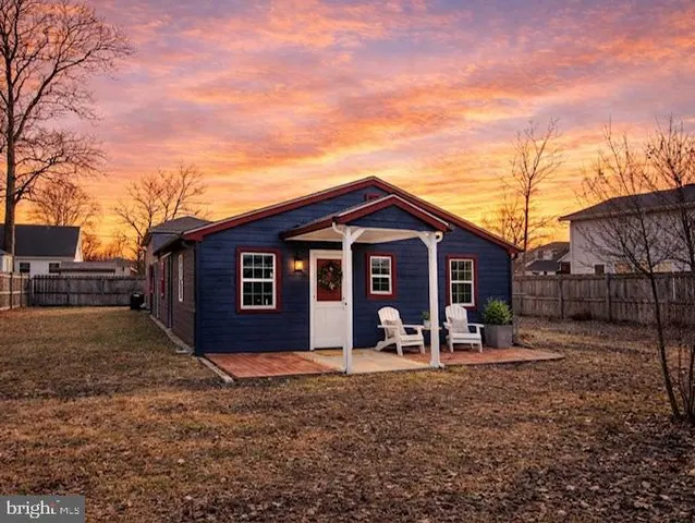 a view of a house with a yard covered in snow