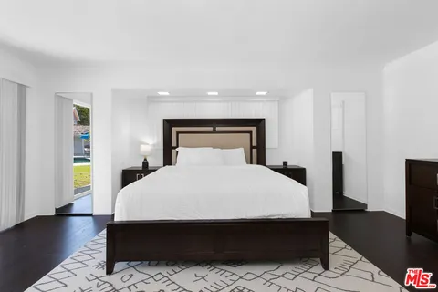 a room with a bed and a flat screen tv