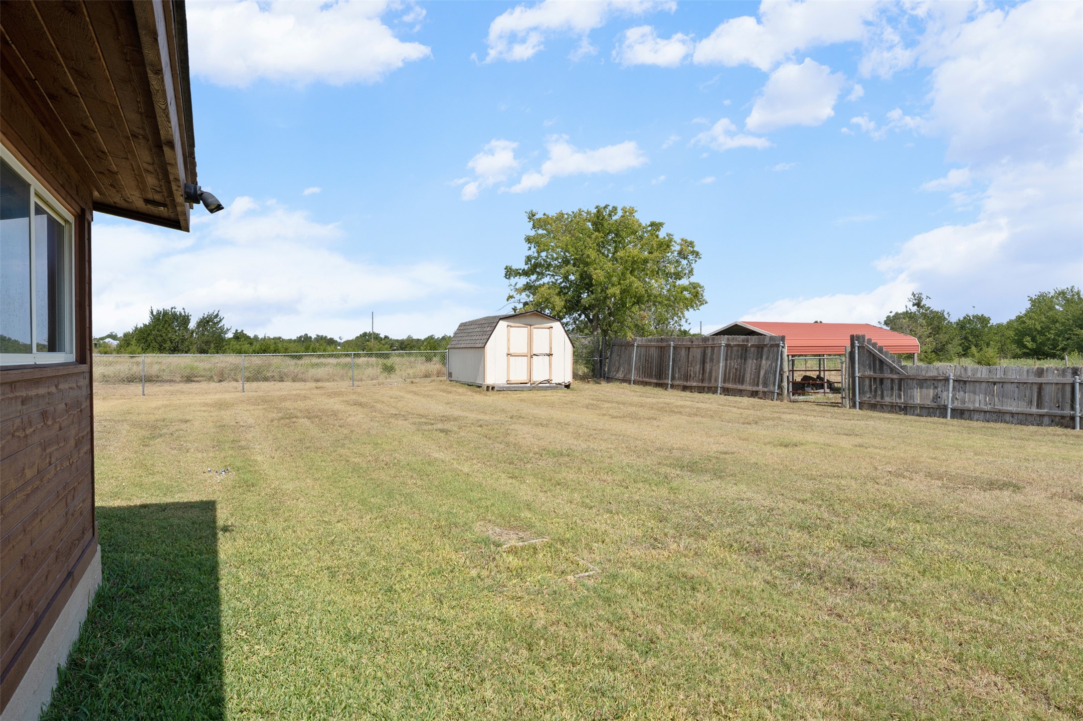 1512 Panther Loop Pflugerville, TX 78660 - Photo 31 of 40 A spacious backyard provides ample green space and useful outbuildings.