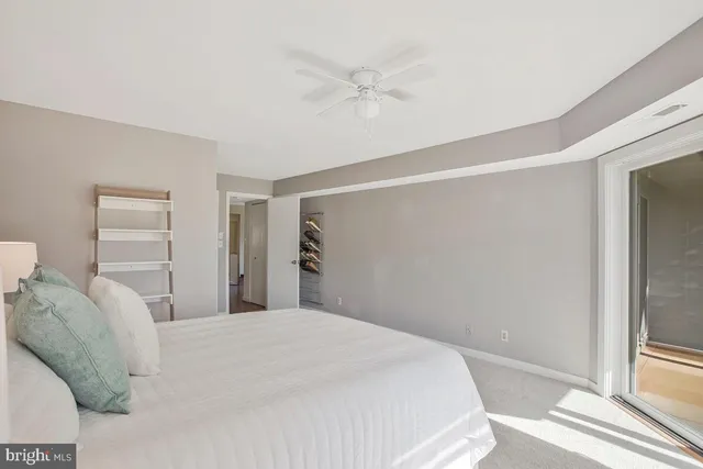 a spacious bedroom with a bed and a walk in closet