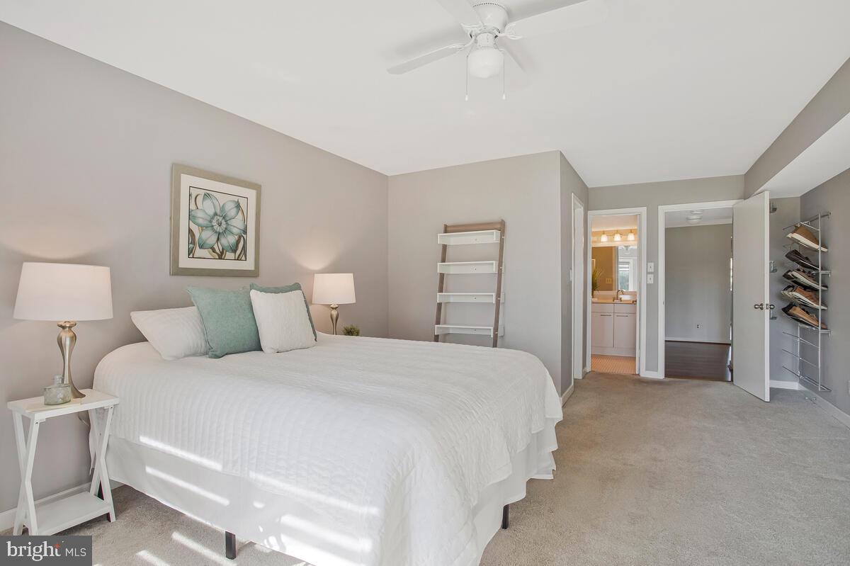 7002 Channel Village Court, Unit 101 Annapolis, MD 21403 - Photo 16 of 57 a spacious bedroom with a bed and a walk in closet