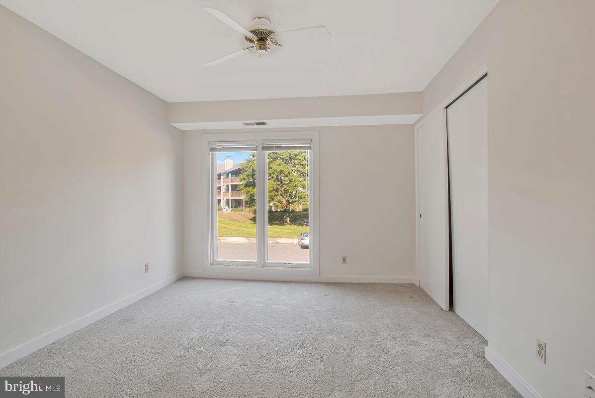 7002 Channel Village Court, Unit 101 Annapolis, MD 21403 - Photo 18 of 57 an empty room with a empty space and windows