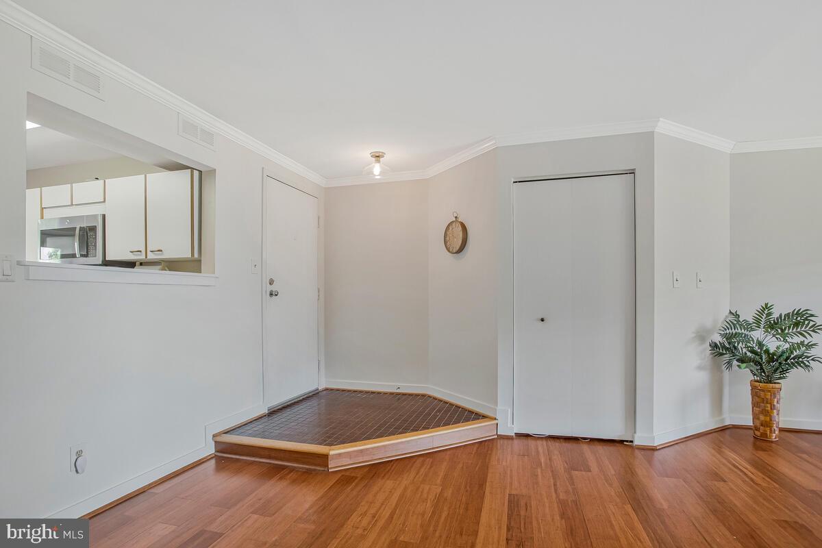 7002 Channel Village Court, Unit 101 Annapolis, MD 21403 - Photo 2 of 57 a view of an empty room with wooden floor