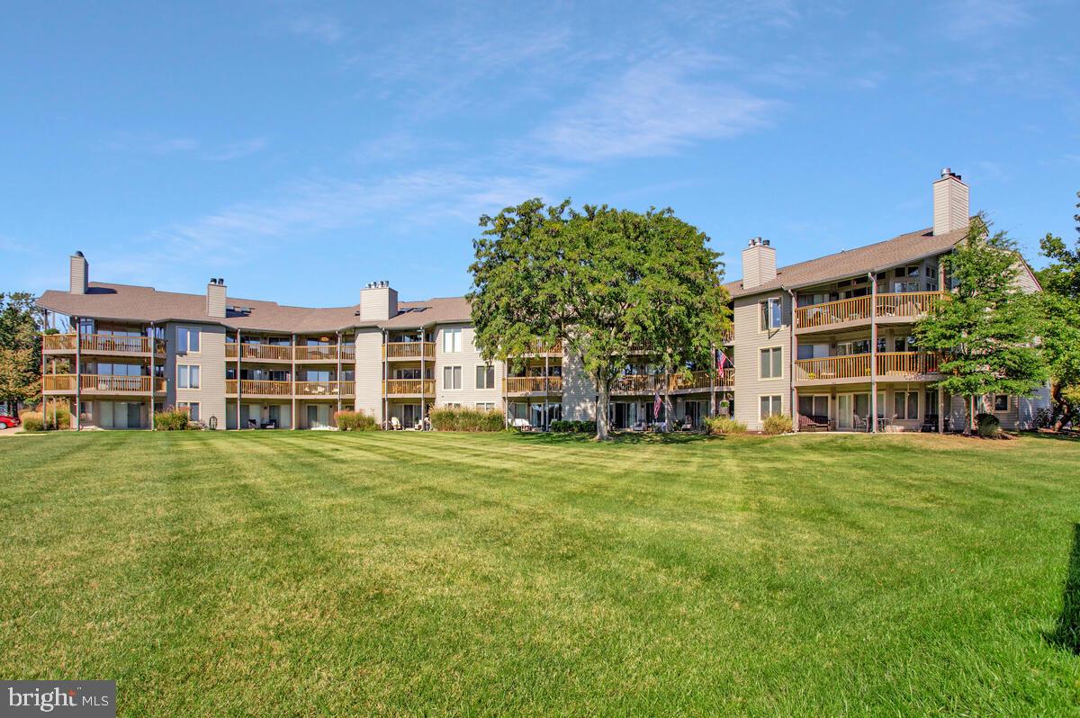 7002 Channel Village Court, Unit 101 Annapolis, MD 21403 - Photo 34 of 57 front view of a building with a garden