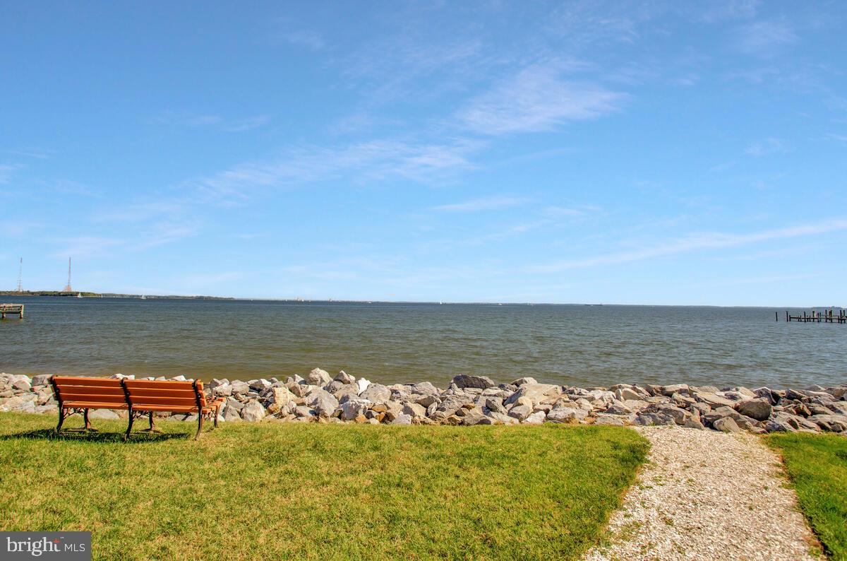 7002 Channel Village Court, Unit 101 Annapolis, MD 21403 - Photo 38 of 57 a view of a lake with table and chairs