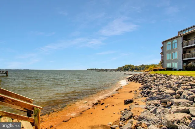 a view of a street with a building and trees in the background