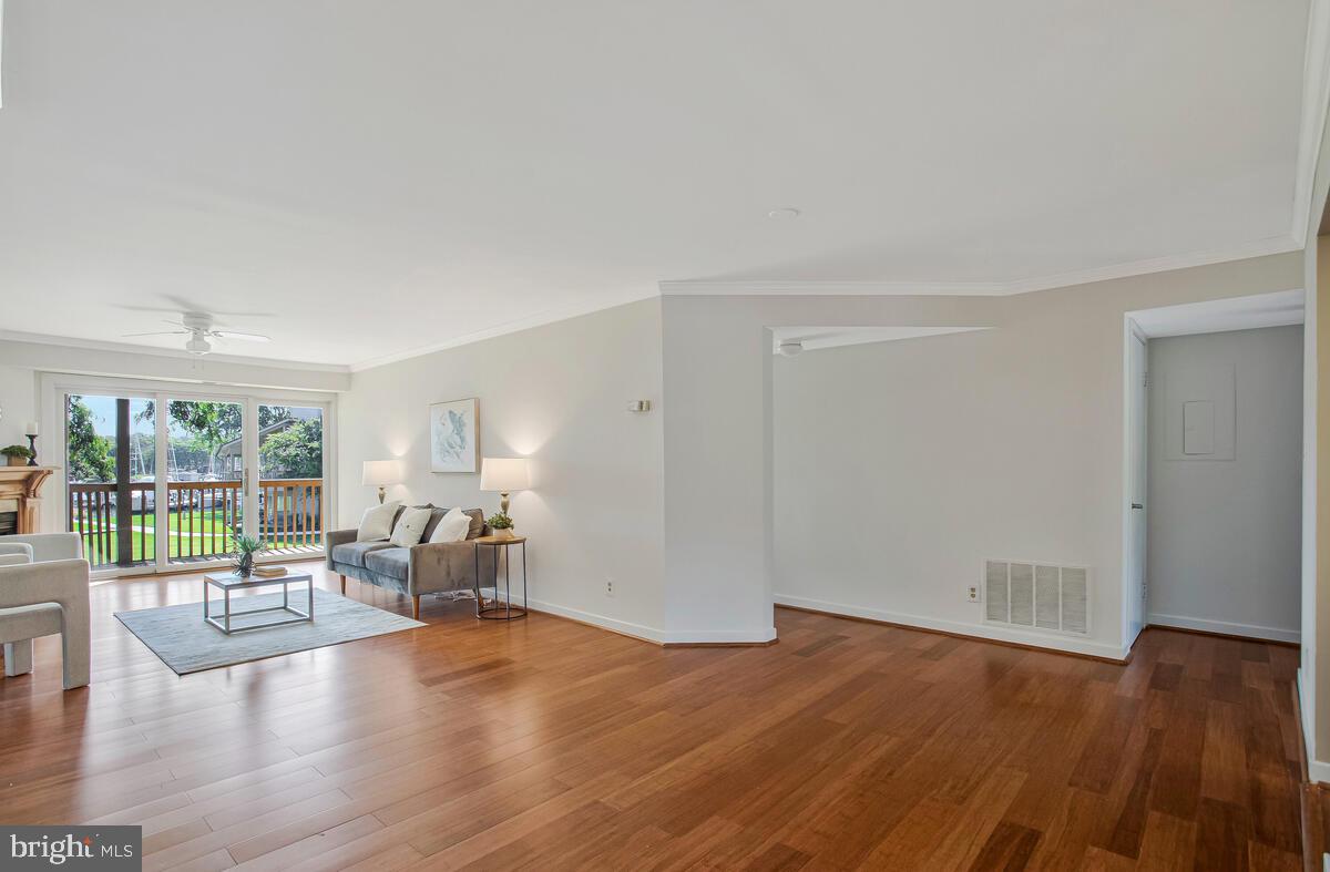 7002 Channel Village Court, Unit 101 Annapolis, MD 21403 - Photo 5 of 57 a living room with furniture and large windows