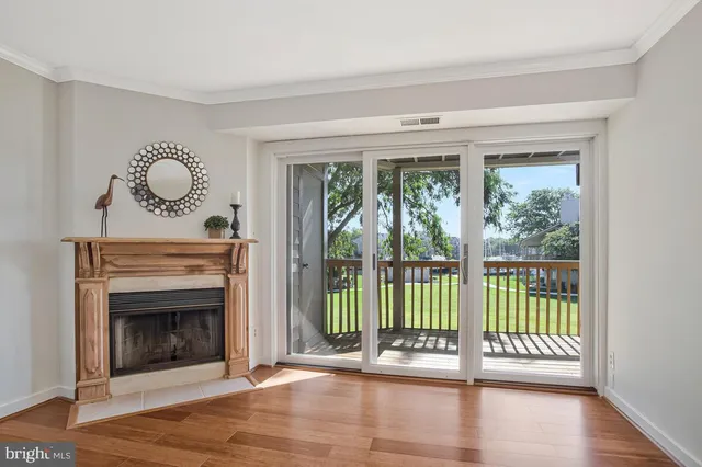 a view of a livingroom with wooden floor a fireplace