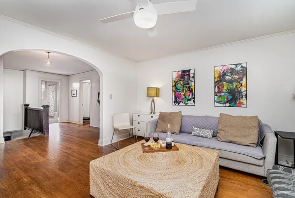a living room with furniture and a wooden floor