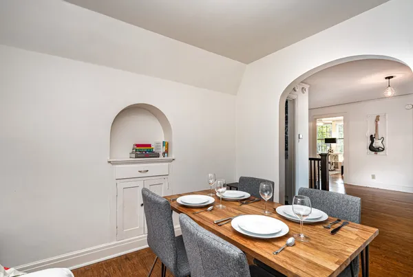a dining room with furniture and wooden floor