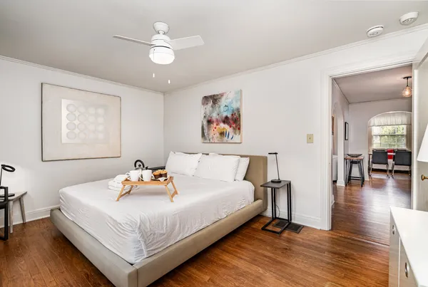 a bedroom with a bed and wooden floor