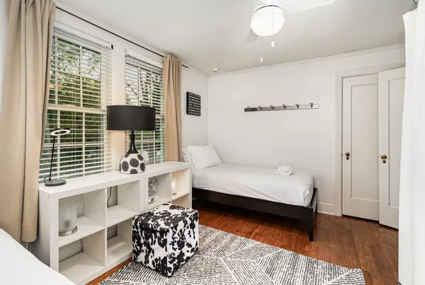 a bedroom with furniture and a window