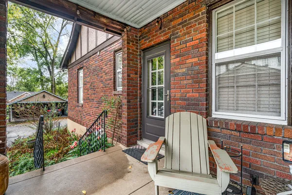 a view of patio with a chairs and table in the patio