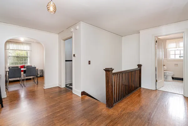 a view of a livingroom with wooden floor and furniture
