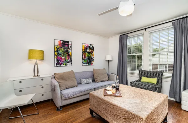 a living room with furniture and wooden floor