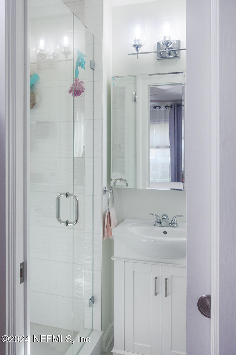 1117 Old Hickory Road Jacksonville, FL 32207 - Photo 11 of 14 a bathroom with a shower sink and mirror