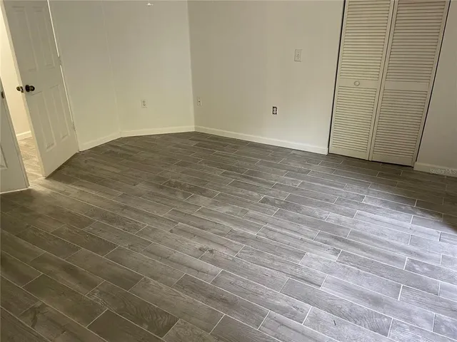 a view of a room with wooden floor