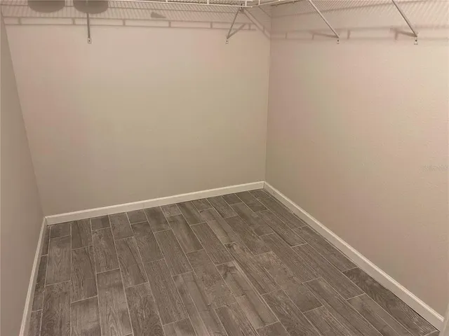 a view of a room with wooden floor