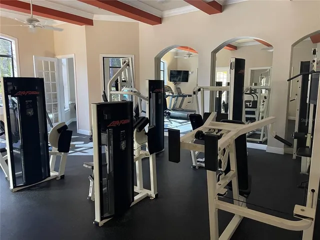 a room with gym equipment and a large window