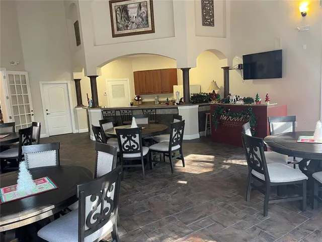 a view of a balcony with chairs and large windows