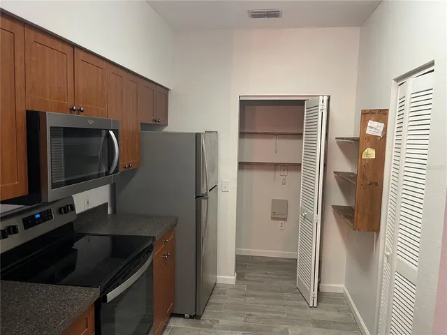 a kitchen with a refrigerator and a sink