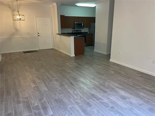 a kitchen with granite countertop a stove and cabinets