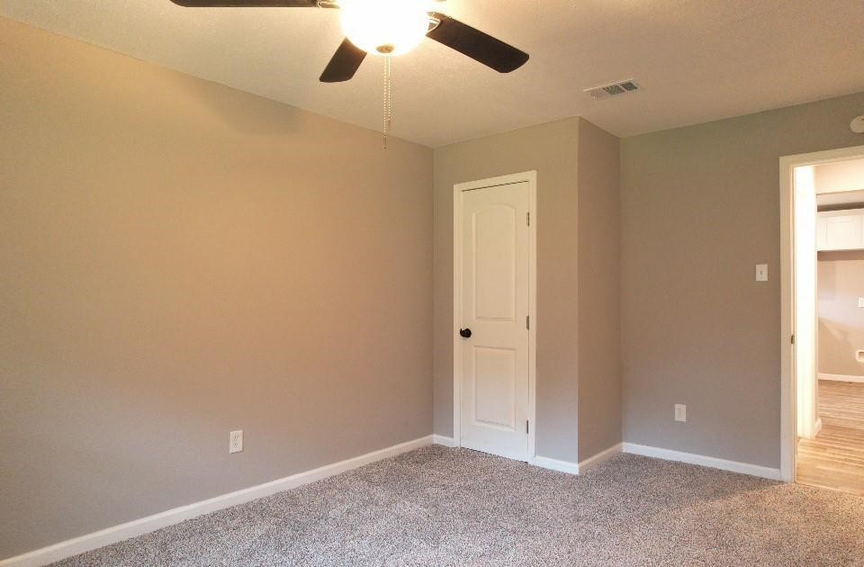 25373 Goodson Road Splendora, TX 77372 - Photo 14 of 41 Room with ceiling fan, plaster walls, and laminate flooring—perfect for a remodel or flip.