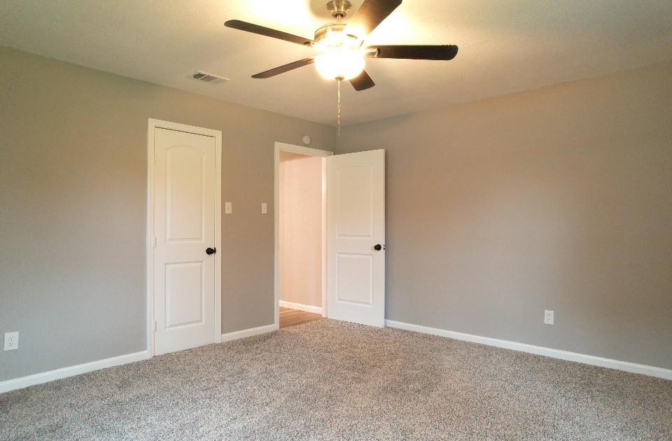 25373 Goodson Road Splendora, TX 77372 - Photo 20 of 41 Inviting room with a ceiling fan, stylish flooring, and elegant moldings—ideal for relaxation or renovation.