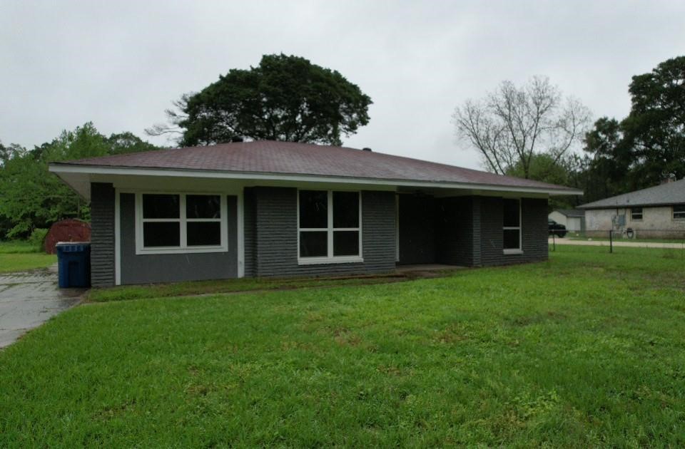 25373 Goodson Road Splendora, TX 77372 - Photo 40 of 41 Charming home with a welcoming porch and spacious, green yard—perfect for outdoor enjoyment and gardening.