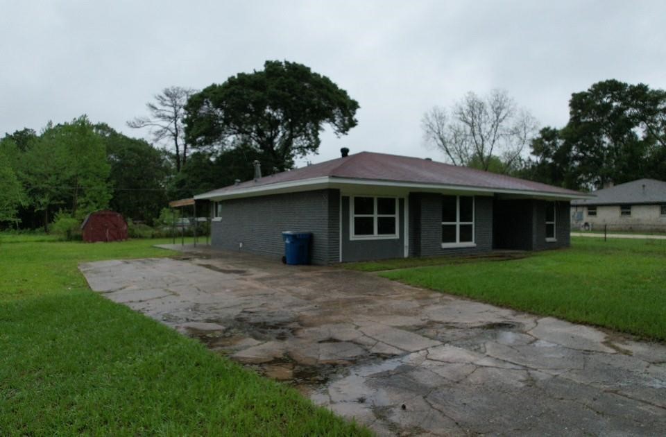 25373 Goodson Road Splendora, TX 77372 - Photo 41 of 41 Charming home with a spacious driveway, lush yard, and welcoming porch in a peaceful, tree-lined setting.