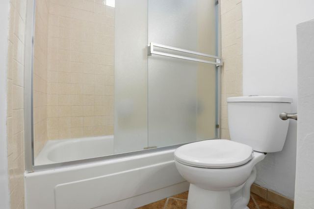 a bathroom with a toilet and a shower