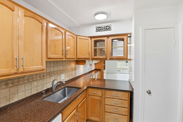 a kitchen with a sink and a window
