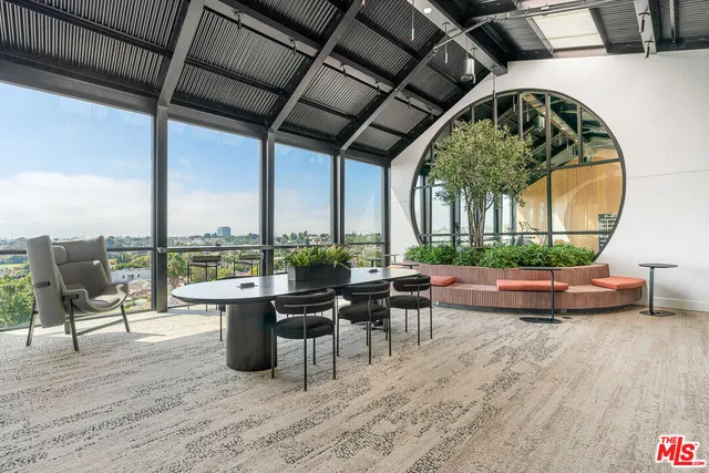 a living room with furniture fireplace and floor to ceiling windows