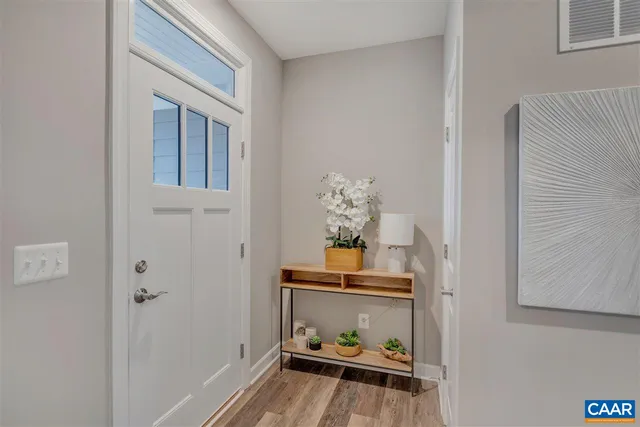 a room with furniture a rug and a wall painting