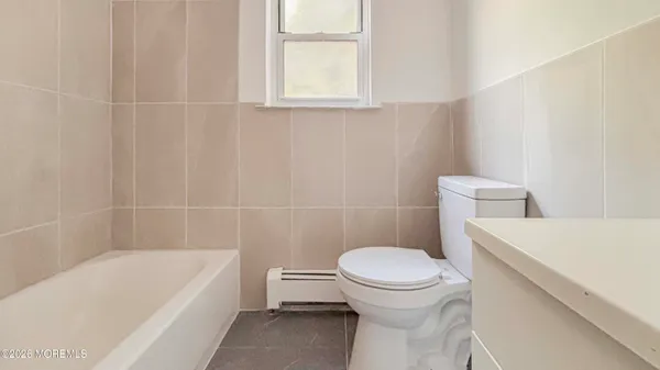 a bathroom with a sink a toilet and bathtub