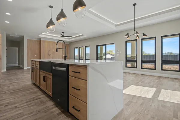 a kitchen with stainless steel appliances kitchen island granite countertop a refrigerator and cabinets