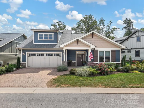 a front view of a house with a garden and plants