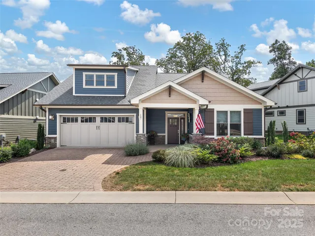 a front view of a house with a garden and plants
