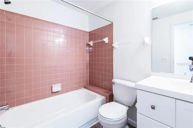 a bathroom with a toilet a sink and bathtub