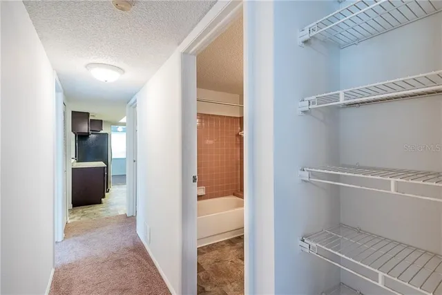 a view of a hallway with a furniture and an empty room
