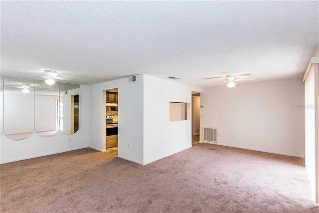 an empty room with a empty space and windows