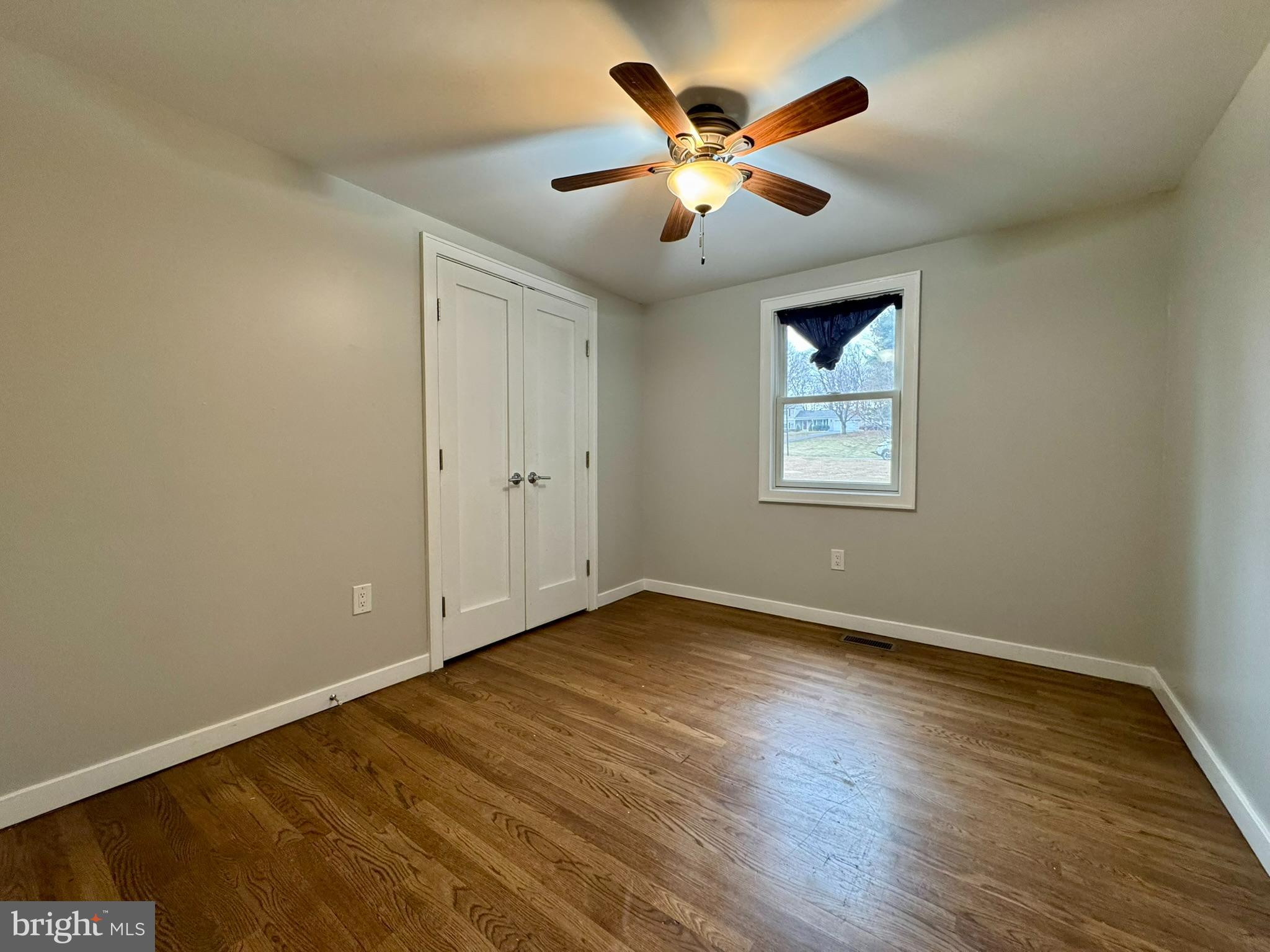 9813 Moyer Road Damascus, MD 20872 - Photo 11 of 31 an empty room with wooden floor and windows